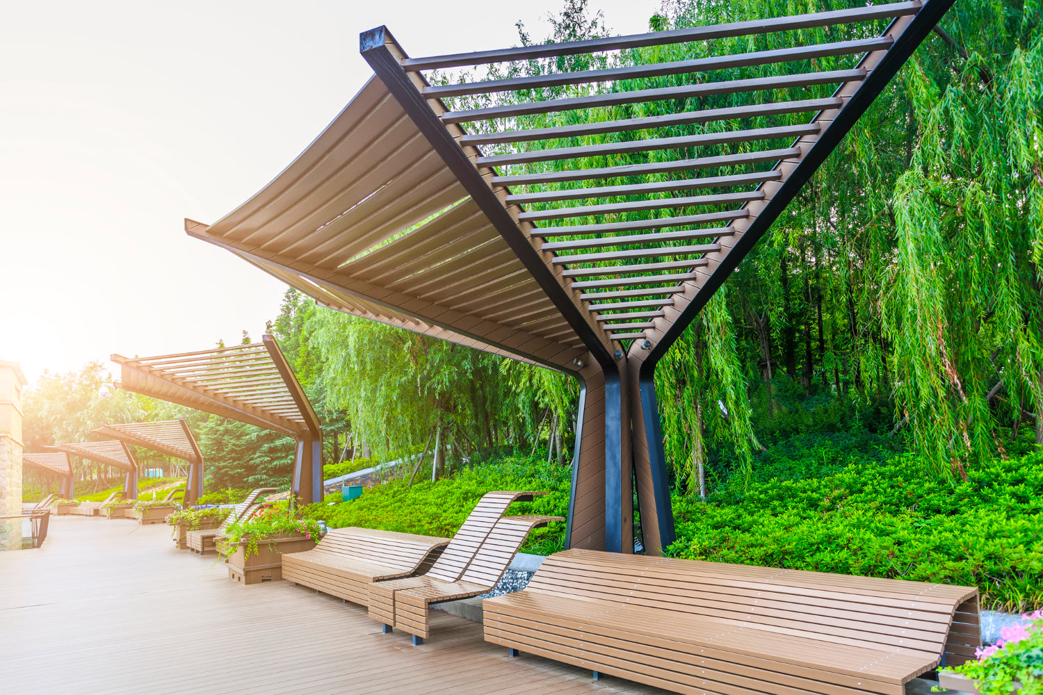 Pergola providing shade for benches on wooden walkway