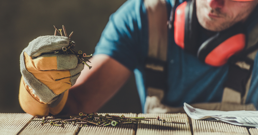Person working with tools and materials on a wooden surface
