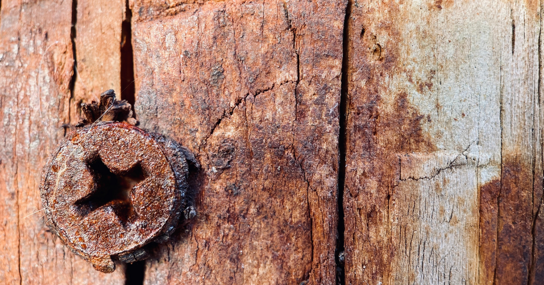 Rusty screw on a wooden surface
