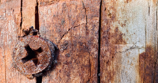 Rusty screw on a wooden surface