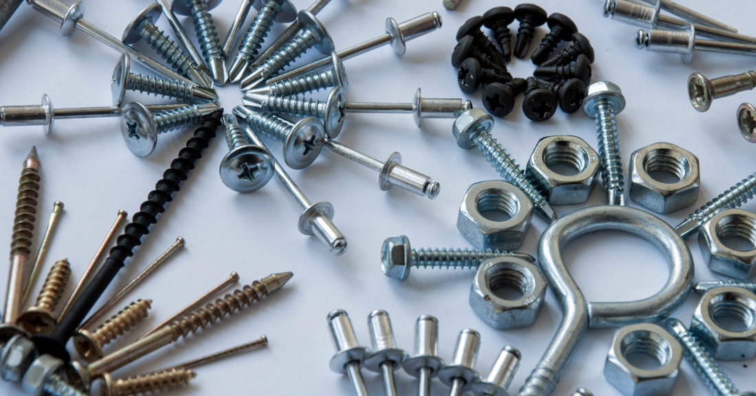 Assorted screws, bolts, and nuts on a white background