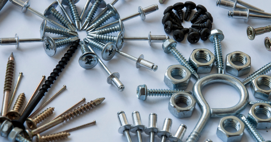 Assorted screws, bolts, and nuts on a white background