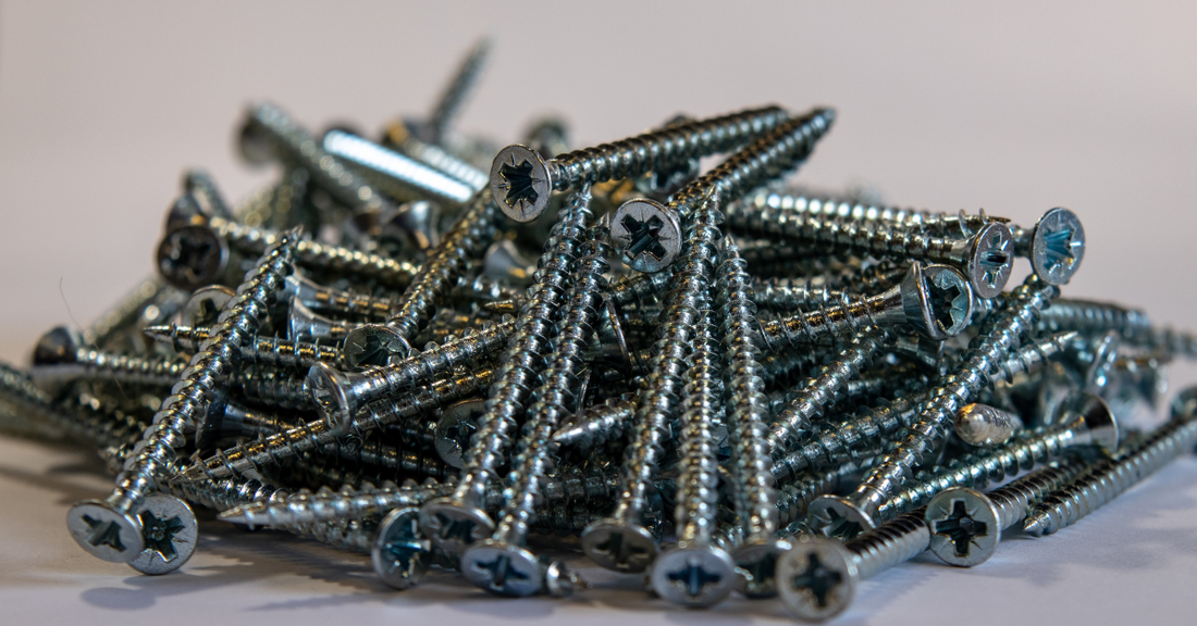 Close-up of a large pile of green powder coated  screws